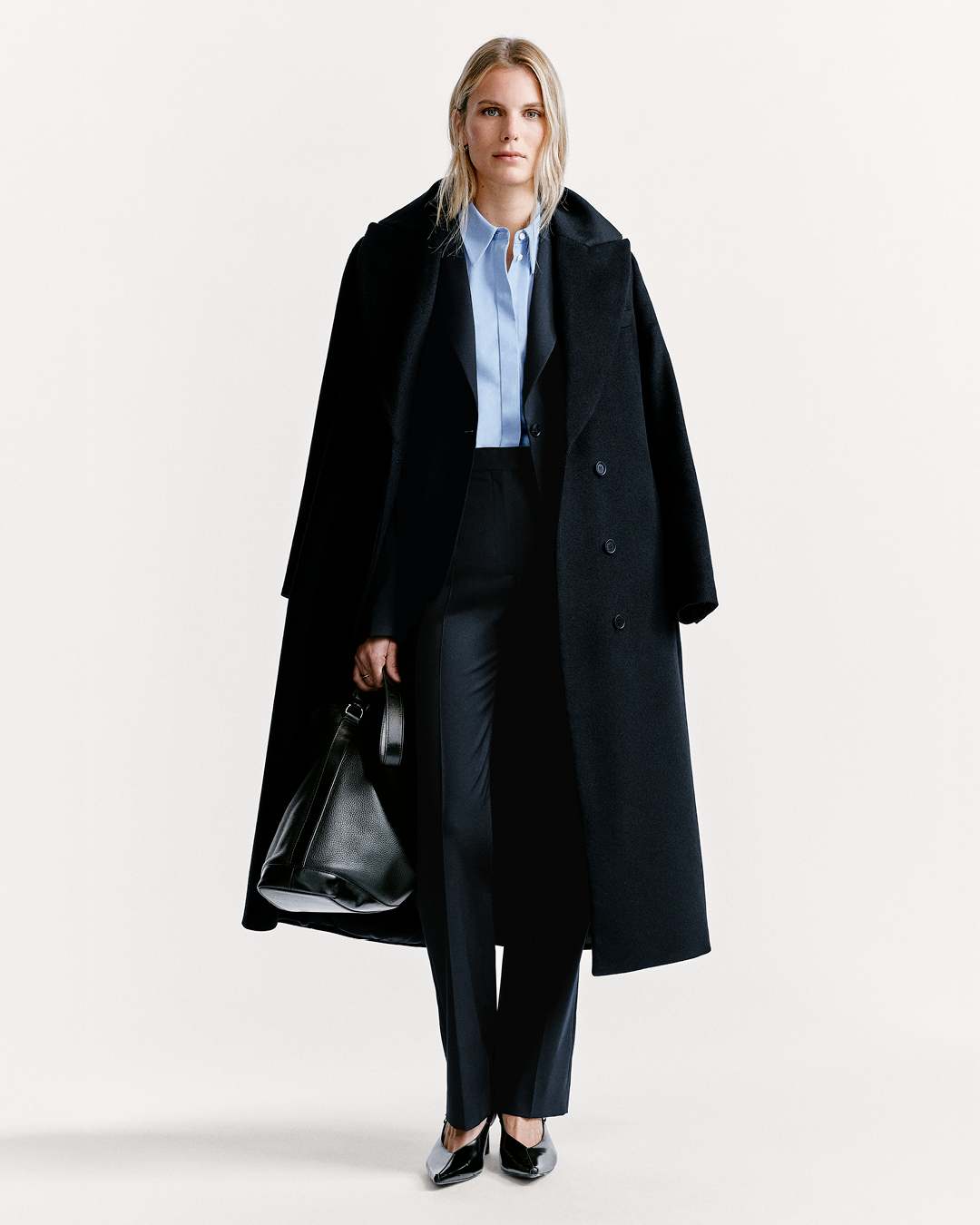 woman in coat and pant outfit